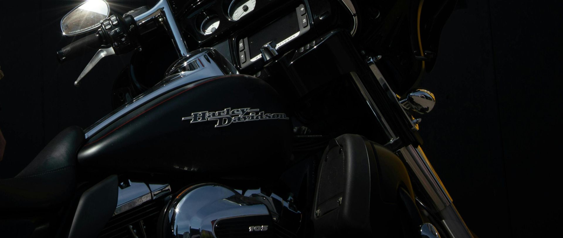 Young Man Standing by a Parked Motorcycle at Night